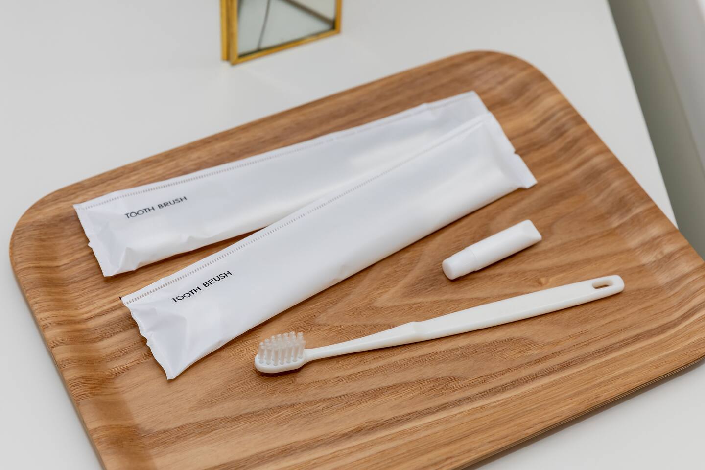 Individually wrapped guest toothbrushes on tray
